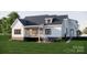 Backyard features a well-manicured lawn, deck, fire pit, and comfortable seating area at 2910A Williams Rd, Matthews, NC 28105