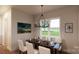 Elegant dining room with stylish chandelier, seating for six, and a view of the outdoors at 2910A Williams Rd, Matthews, NC 28105