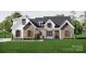 Charming modern farmhouse-style home with a well-manicured lawn, and brick and white siding at 2910A Williams Rd, Matthews, NC 28105