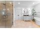 Bright bathroom featuring a walk-in shower, marble vanity, and a freestanding tub at 2924 Chelsea Dr, Charlotte, NC 28209