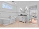 Bright bathroom with soaking tub, double vanity with granite counters, and paneled walls at 2924 Chelsea Dr, Charlotte, NC 28209