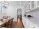 Charming breakfast nook with built-in seating, wooden table, and a view into the modern kitchen at 2924 Chelsea Dr, Charlotte, NC 28209