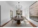 Bright dining room features modern lighting, large windows, and a view of the outdoor landscape at 2924 Chelsea Dr, Charlotte, NC 28209