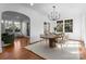 Elegant dining room with modern chandelier, large windows, and easy access to the living spaces at 2924 Chelsea Dr, Charlotte, NC 28209