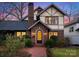 Charming Tudor-style home with brick facade, arched entryway, lush landscaping, and a welcoming brick walkway at 2924 Chelsea Dr, Charlotte, NC 28209