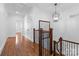 Hallway with dark wood floors, a decorative light fixture, and beautiful trim at 2924 Chelsea Dr, Charlotte, NC 28209