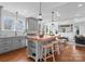 Open kitchen with wood top island, gray cabinets, and seamless flow into the living room at 2924 Chelsea Dr, Charlotte, NC 28209