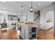 Bright kitchen features a center island with butcher block top, custom gray cabinets, and stainless appliances at 2924 Chelsea Dr, Charlotte, NC 28209