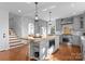 Bright kitchen features a center island with butcher block top, custom gray cabinets, and stainless appliances at 2924 Chelsea Dr, Charlotte, NC 28209