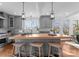 Spacious kitchen with a large wood top island, pendant lighting, and sleek gray cabinetry at 2924 Chelsea Dr, Charlotte, NC 28209