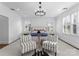 Bright main bedroom with shuttered windows, chandelier, and a neutral color palette at 2924 Chelsea Dr, Charlotte, NC 28209