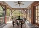 Screened porch with a ceiling fan and a dining table at 2924 Chelsea Dr, Charlotte, NC 28209