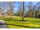 Backyard with a well-maintained lawn, mature trees, and stone path, perfect for outdoor activities at 308 Dakota St, Kannapolis, NC 28083