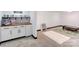 Basement snack bar area with wood countertop, white cabinets, and a play area with toys for children at 308 Dakota St, Kannapolis, NC 28083