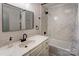 Updated bathroom with a marbled sink countertop, framed mirror, and a shower-tub combo with marbled tile surround at 308 Dakota St, Kannapolis, NC 28083
