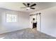 This bedroom offers a ceiling fan, carpet flooring, a window view, and an ensuite bathroom at 308 Dakota St, Kannapolis, NC 28083