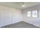 Cozy bedroom boasts neutral walls, carpeted floors, a window with a view, and a closet for plenty of storage at 308 Dakota St, Kannapolis, NC 28083