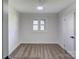 Bright bedroom featuring neutral walls, carpeted floors, a window, and a ceiling fan with built-in light at 308 Dakota St, Kannapolis, NC 28083