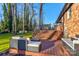 Expansive wooden deck with comfortable seating areas and stairs, perfect for outdoor relaxation and enjoying the serene backyard at 308 Dakota St, Kannapolis, NC 28083
