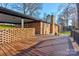 A spacious wooden deck on a brick home, ideal for outdoor relaxation and entertaining with its beautiful brick surroundings at 308 Dakota St, Kannapolis, NC 28083