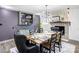 A dining room features dark walls, a light fixture, built-in shelving with decor and seating for six at 308 Dakota St, Kannapolis, NC 28083