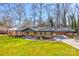 Charming brick home featuring a well-manicured lawn and convenient carport at 308 Dakota St, Kannapolis, NC 28083