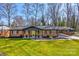 Charming brick home featuring a well-manicured lawn and convenient carport at 308 Dakota St, Kannapolis, NC 28083