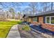 A charming brick home with a well-maintained yard and walkway at 308 Dakota St, Kannapolis, NC 28083