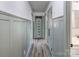 Hallway with gray board and batten walls, wood floors, and a built-in storage dresser and cabinets at 308 Dakota St, Kannapolis, NC 28083