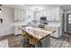 Modern kitchen featuring white cabinets and a large island with seating at 308 Dakota St, Kannapolis, NC 28083