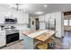 Modern kitchen featuring white cabinets and a large island with seating at 308 Dakota St, Kannapolis, NC 28083