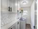 Bright laundry room features ample storage space with modern cabinetry and geometric backsplash at 308 Dakota St, Kannapolis, NC 28083