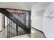 Open staircase to basement featuring modern wooden railing, vinyl flooring, and decorative display shelves at 308 Dakota St, Kannapolis, NC 28083