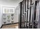 Modern staircase to basement with wooden railing, vinyl flooring, and decorative display shelves with plants at 308 Dakota St, Kannapolis, NC 28083