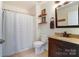 This bathroom features a shower/tub combo, granite vanity top, and dark wood cabinets, creating an elegant space at 314 S Bruns Ave, Charlotte, NC 28208