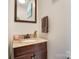 This bathroom features a granite vanity top and dark wood cabinets, creating a cozy and elegant space at 314 S Bruns Ave, Charlotte, NC 28208