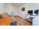 Bright bedroom with a desk setup, futon, wood floors, and a door at 314 S Bruns Ave, Charlotte, NC 28208