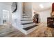 Inviting entryway features modern staircase, wood floors, and seamless access to the kitchen at 314 S Bruns Ave, Charlotte, NC 28208