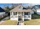 Charming home featuring a decorative front porch with white railings and brick foundation at 314 S Bruns Ave, Charlotte, NC 28208