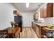 Cozy kitchen featuring wood cabinets, a table for two, and modern appliances at 314 S Bruns Ave, Charlotte, NC 28208