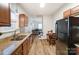 Bright kitchen with stainless steel appliances, wooden cabinets, a view to living room, and wood-style flooring at 314 S Bruns Ave, Charlotte, NC 28208