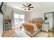 This bright main bedroom features lots of natural light and a modern ceiling fan at 314 S Bruns Ave, Charlotte, NC 28208