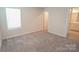 Bright bedroom with plush carpet, a window, and an ensuite bathroom offering a comfortable and private retreat at 3207 Lisburn St, Charlotte, NC 28227