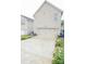 Rear view of a two-story home featuring an attached two-car garage and a driveway surrounded by flower beds at 3207 Lisburn St, Charlotte, NC 28227