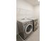 Functional laundry room equipped with modern washer and dryer units and wire rack shelving for added storage convenience at 3207 Lisburn St, Charlotte, NC 28227