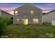 Backyard view of house, vinyl siding, and the sliding glass doors at twilight at 3627 Alexander Forest Dr, Charlotte, NC 28269