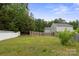 Spacious backyard featuring a wooden fence and plenty of green space and trees at 3627 Alexander Forest Dr, Charlotte, NC 28269