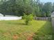 Large backyard with fencing and a small tree in the middle of the yard at 3627 Alexander Forest Dr, Charlotte, NC 28269