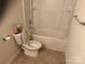 Standard bathroom featuring a toilet, shower-tub combo, and neutral color scheme at 3627 Alexander Forest Dr, Charlotte, NC 28269