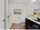 Bright bathroom featuring a bathtub and a vanity with dark wood cabinets at 3627 Alexander Forest Dr, Charlotte, NC 28269
